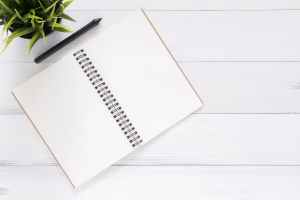 white blank study notebook with pen
